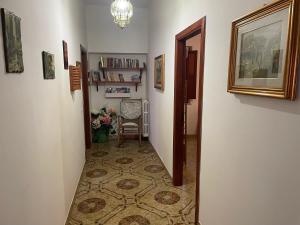 a hallway with a chair and a table in a room at La Casa di Luisa Alloggio Familiare 3 camere in Vico Equense