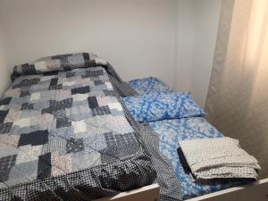 a bed with a quilt on it in a room at Apartamento Playa Cárabos in Melilla