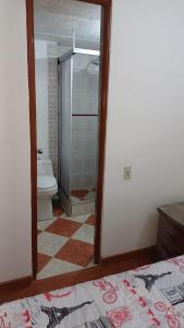 a bathroom with a mirror and a toilet in a room at Apartamento Ciudad Salitre Bogota - Amoblado in Bogotá