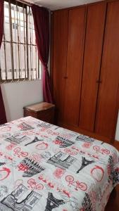 a bedroom with a bed with a comforter on it at Apartamento Ciudad Salitre Bogota - Amoblado in Bogotá