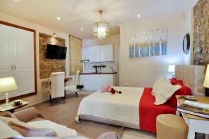 a bedroom with a bed and a living room at Venetian Suite Mitropolis new in Corfu