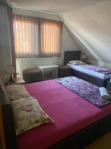 two beds in a room with a attic at Restoran&Motel and apartmants Lovacka prica in Tešanj