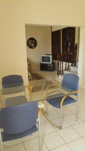 a living room with two chairs and a glass table at #11 princess apartments, 230mt to senegambia strip in Sere Kunda