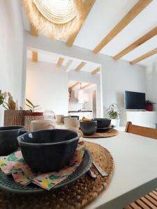 a table with bowls and plates on top of it at El Hogarin de Veronica in Gijón