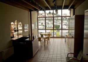 a kitchen with a table and a large window at Apartamentos Marina in Naveces