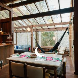 a dining room with a hammock in a house at Casa de Madeira - Sao Jorge GO in Sao Jorge
