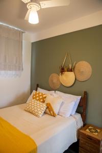 a bedroom with a bed with baskets on the wall at Pousada do Beco in Tiradentes