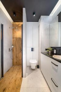 a bathroom with a toilet and a sink at Cozy Modern Corner by ECRU WWA59 in Warsaw