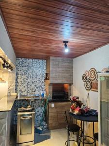 a kitchen with a wooden ceiling and a counter top at Rancho condomínio Terras d barra 