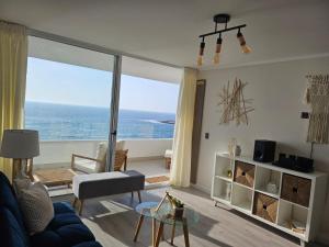 a living room with a view of the ocean at Departamento con espectacular vista al mar Arica, Condominio Ayllu in Arica