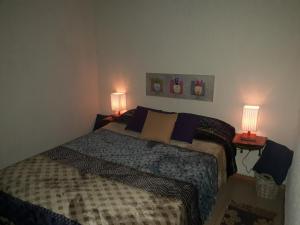 1 dormitorio con 1 cama y 2 lámparas en 2 mesas en Sentirse en casa, en Puerto Iguazú 48 fotos más