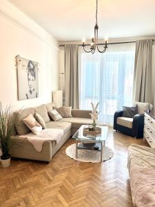 a living room with a couch and a table at Audrey Hepburn Apartment old town Air Conditioned in Bratislava