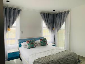 a bedroom with a bed with two pillows at MILANI SEA VIEW in Kentani