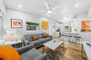 a living room with a couch and a table at Midtown Cottage - In the heart of Cocoa Beach in Cocoa Beach