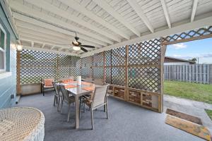 a patio with a table and chairs and a fence at Midtown Cottage - In the heart of Cocoa Beach in Cocoa Beach