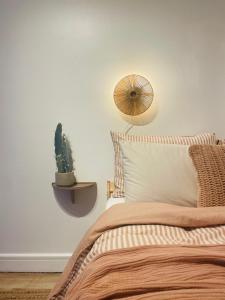 a bedroom with a bed with a cactus on the wall at The Maiden Studio. Derry city. Studio Apartment. in Derry Londonderry