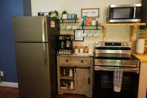 a kitchen with a refrigerator and a microwave at Walkout Basement Near Creation Museum in Hebron