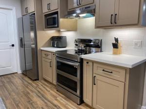 a kitchen with a stove and a refrigerator at NEW! Luxury Home in Central McAllen in McAllen
