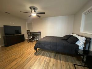 a bedroom with a bed and a flat screen tv at NEW! Luxury Home in Central McAllen in McAllen