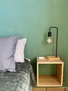 1 cama con mesita de noche junto a una pared verde en Depto. equipado, Dos Habitaciones, Zona Céntrica, en Tulancingo