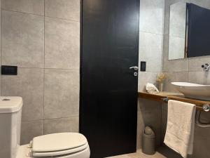 a bathroom with a toilet and a sink at OCEANO a dos cuadras de la playa in Las Gaviotas +9 photos
