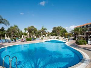 a swimming pool at a resort with a bridge at Anmaria Beach Hotel & Spa in Ayia Napa