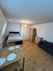 a room with a bed and a table with two sinks at Leicester Studio at City Centre with free parking in Leicester