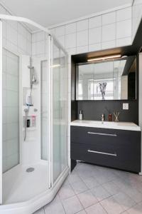 a bathroom with a shower and a sink at Aalesund centrum apartement. in Ålesund