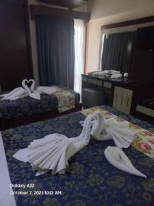 Postel nebo postele na pokoji v ubytování Windsor Hotel Luxor