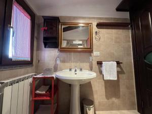 a bathroom with a sink and a mirror at [FREE PARKING] La Bianca Neve Cottage in Castel di Sangro