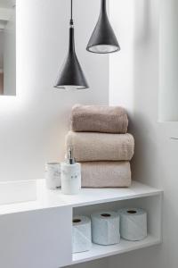a pile of towels on a shelf in a bathroom at Luxury Living in Trocadéro in Paris