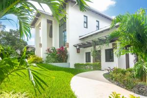 a white house with a walkway at Ocean Pearl home in Roatan