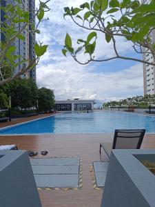 a large swimming pool with a building in the background at FA Homestay Alanis, Near KLIA in Sepang