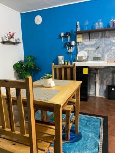 ein Esszimmer mit einem Tisch und einer blauen Wand in der Unterkunft PANCHITO’S in Isla Mujeres