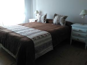 Una cama o camas en una habitación de Hotel La Madrileña