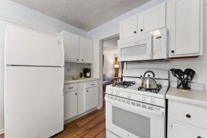 a kitchen with white cabinets and a white stove top oven at 2 Bedroom/1 bath Upper Duplex in Hopkins