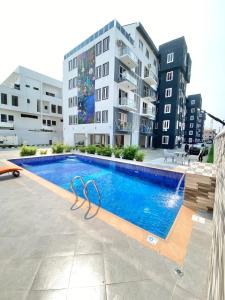 a swimming pool in front of a building at Luxury 3BR + 3.5bath apartment in Victoria Island with pool in Lagos