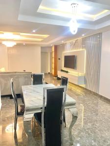 a conference room with a table and chairs and a tv at Luxury 3BR + 3.5bath apartment in Victoria Island with pool in Lagos