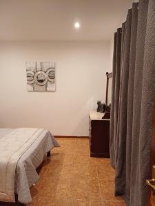 a bedroom with a bed and curtains in a room at Amarante Residence in Amarante