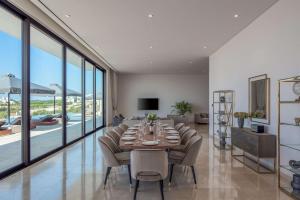 a dining room with a long table and chairs at Cap St Georges Hotel & Resort in Peyia