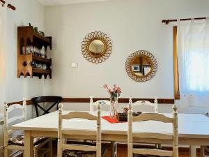 uma sala de jantar com mesa, cadeiras e espelhos em House with garden, games area and shared pool em Montseny