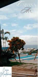 a sign for a resort with a pool and a tree at Casa Montemar Hotel-San Vicente in San Vicente