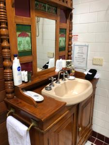 a bathroom with a sink and a mirror at Secrets Hideaway in Blackheath