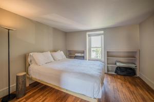 a bedroom with a bed and a window at Row House Loft in Downtown Harrisburg near Hershey in Harrisburg