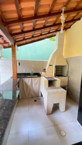 a kitchen with a sink and a counter top at Espaço Zoey in Búzios