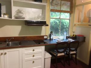 a kitchen with a counter and a sink and a window at Secrets Hideaway in Blackheath