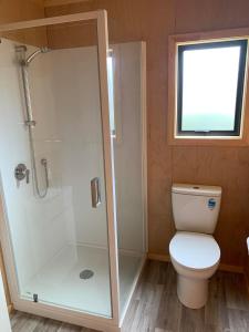 a bathroom with a toilet and a shower at Charming on Charles in Cooks Beach