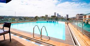 a swimming pool on the roof of a building at Luxurious suite apartment in Nairobi