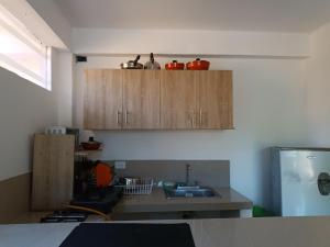 a kitchen with wooden cabinets and a sink at Cabaña frente a la playa in Tubará