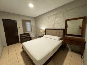 a bedroom with a bed and a dresser and a mirror at Casa P in Candelaria